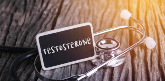 A stethoscope next to a chalkboard sign that reads 'Testosterone'