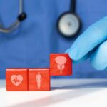 Avoid This Deadly Anti-Aging Trap A doctor's gloved hand placing red blocks with health symbols on a table