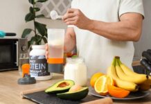 Does Yo-Yo Dieting Damage Metabolism? Person preparing a protein shake with fruits and whey protein powder in a kitchen