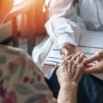 Biology’s Curveball: Muscles Trump Birthday A doctor holding the hand of an elderly patient during a consultation