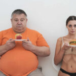 Perfection Diets Quietly Wreck Health? A man holding an apple and a woman holding a hamburger, showcasing contrasting food choices