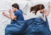 How Your Romantic Relationship SHAPES Your Mind Couple sleeping back to back in bed under blue blanket