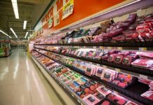 Grocery store meat aisle stocked with packaged beef and poultry