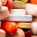 Heart-Stopping ED Pills Invade the UK A close-up view of a variety of colorful pills and tablets stacked together