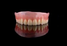 Upper denture on black reflective surface