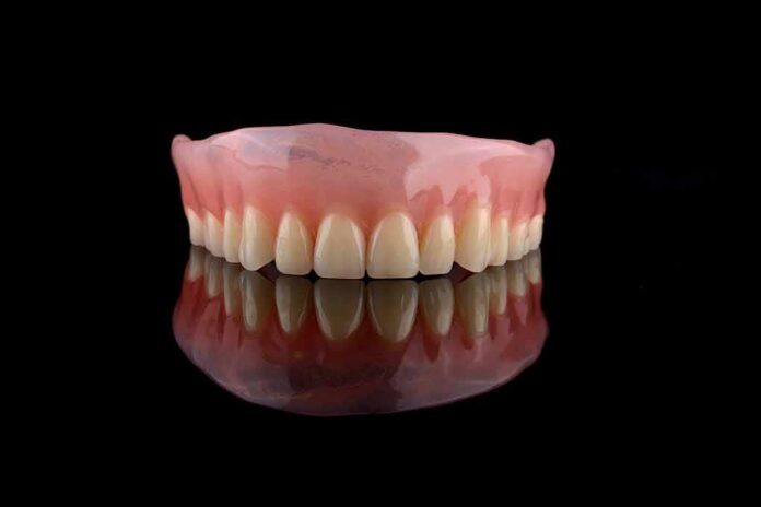 Upper denture on black reflective surface
