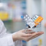Popular Diabetes–Heartburn Duo Quietly Destroys Nerves A doctor holding a miniature shopping cart filled with various medication packs