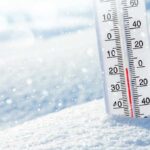 Thermometer in snow showing subzero temperature