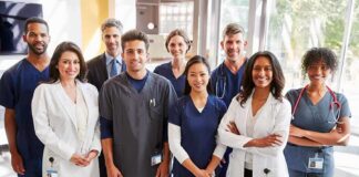Group of healthcare professionals posing in a hospital corridor