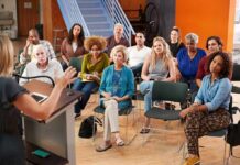 Audience listening to a speaker in a small community meeting room