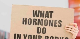 Hands holding a cardboard sign with a health-related question