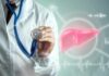 Doctor holding a stethoscope with a digital liver graphic