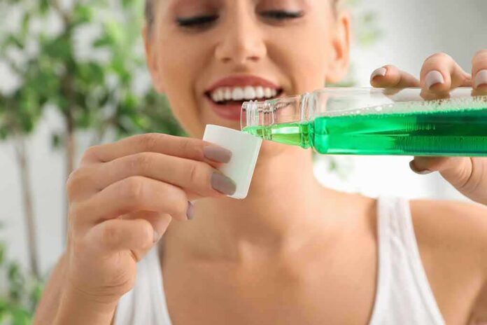 Woman pouring green mouthwash into a cap