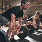 The Most Important Muscle-Building Fundamentals Two people performing deadlifts in a gym